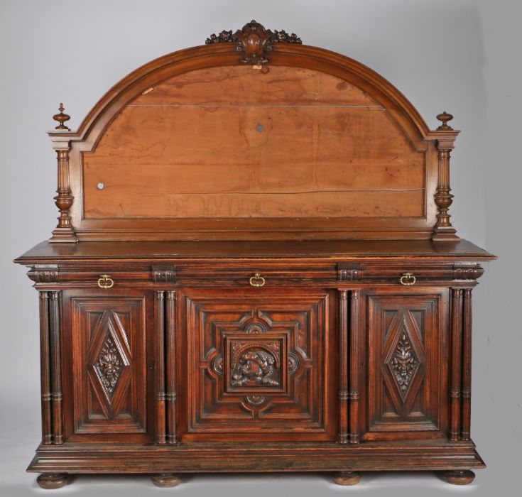 Victorian mahogany sideboard, the arched back with shield and foliate carved pediment and with