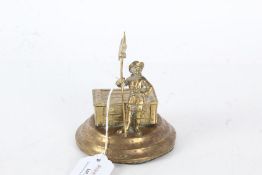 Novelty cast brass vesta case and match striker, in the form of a figure guarding a chest, 9cm