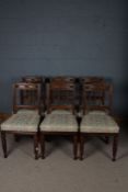 A set of six late 19th/ early 20th century oak dining chairs, with a arched cresting rail above four