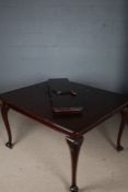 Late Victorian mahogany extending dining table, raised on carved cabriole legs and castors, with one
