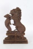 A cast iron door stop in the form of a rampant lion, 39cm high