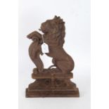 A cast iron door stop in the form of a rampant lion, 39cm high