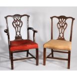 George III style mahogany armchair and single chair, the arched top rail with carved tassels above