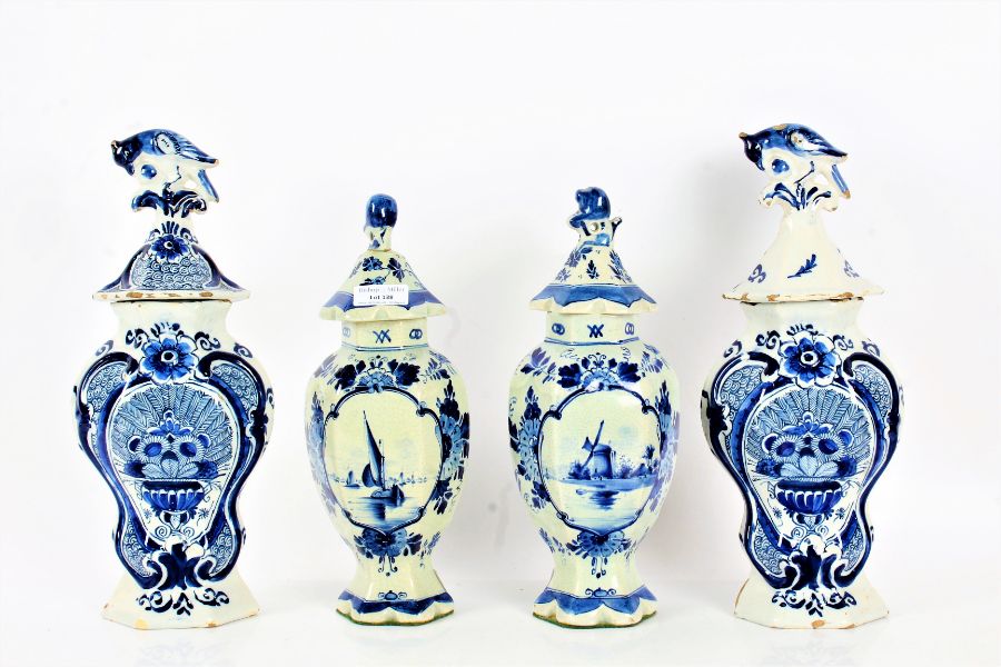 Two pairs of blue and white Delft style vase and covers, one pair with a hexagonal tapering body