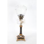 A Victorian oil lamp, with a ormolu and marble base and stem with a clear glass reservoir and shade,