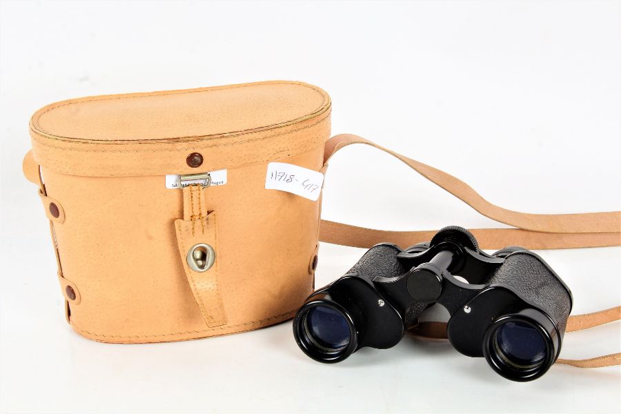 A pair of Cadet coated optics 8 x 30 binoculars housed within a leather case