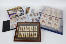 Cigarette and trade cards, mixed lot, housed in two albums and a tin
