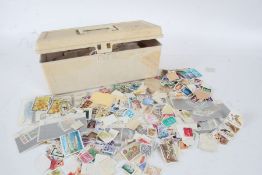 Collection of world stamps, housed in a plastic box
