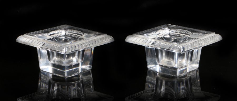 Pair of Lalique clear glass inkwells, of square form, the gadrooned rims surrounding circular