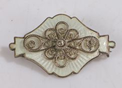 Ivar T. Holth Norwegian silver and white enamel brooch, with central scrolled filigree decoration,