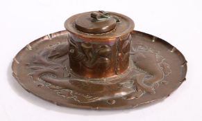 Newlyn Arts and Crafts copper inkwell, the circular beaten hinged cover above a cylindrical stem and
