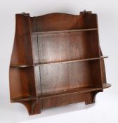 Liberty & Co Ltd. oak open bookcase, with three central shelves flanked by two curved shelves to