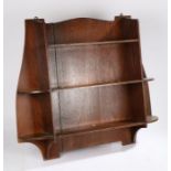 Liberty & Co Ltd. oak open bookcase, with three central shelves flanked by two curved shelves to