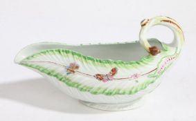 A Derby porcelain sauce boat, 18th Century, decorated with butterflies and flowers and a curled