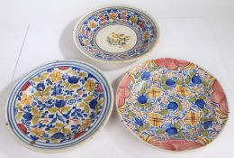 Three French pottery chargers, the first with a central bird and colourful edge, 35cm diameter,