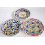 Three French pottery chargers, the first with a central bird and colourful edge, 35cm diameter,