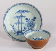 18th Century Nanking Cargo blue and white tea bowl and saucer, circa 1752, decorated with trees,