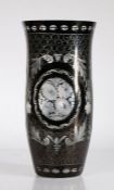 Tall Bohemian black glass vase, with scrolls and flower heads within floral borders, 30cm tall