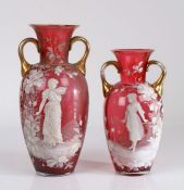 Two Bohemia glass vases, with gilt handles, the bodies decorated with white enamel in the style of