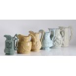 Six early to mid 19th Century relief moulded jugs, the first with a jousting competition, the second