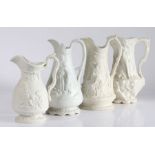 Four early to mid 19th Century relief moulded jugs, each depicting a Classical scene, 20cm high to