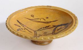 An unusual pottery slipware decorated dish, the wide high rimmed dish with a central fish design,