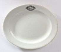 A Victorian oval meat plate, printed in black 'The Busy B Ltd. Meat Purveyors English Imported',