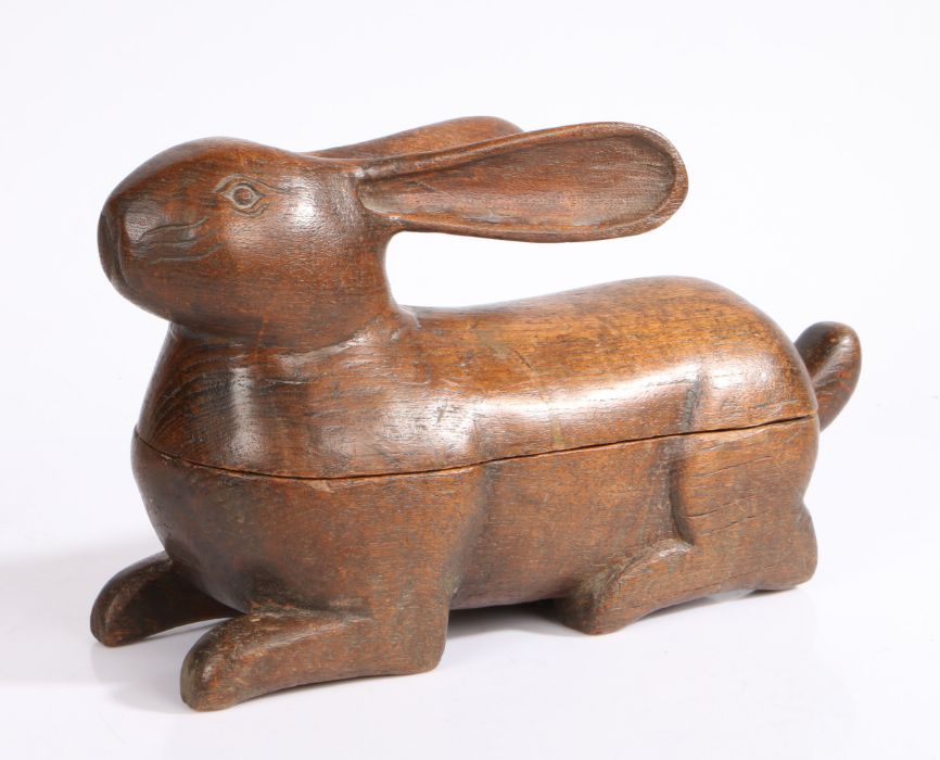 An early 20th century Folk Art carved wooden box & cover, in the form of a recumbent rabbit with