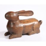 An early 20th century Folk Art carved wooden box & cover, in the form of a recumbent rabbit with