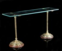 A pair of ornate late Victorian English brass shop display shelf supports, of pedestal form with