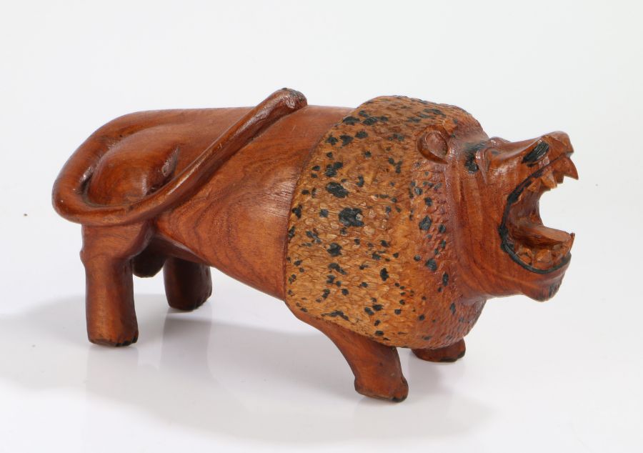 American folk art lion, 20th Century, with an open mouth displaying sharp teeth, standing on all