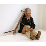 A late 19th/early 20th century handmade and painted wooden puppet in the form of an elderly