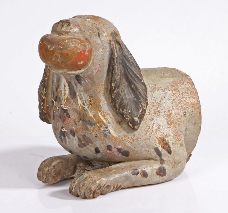 A late 19th/early 20th century Folk Art carved wooden bust of a spaniel biting a ball,