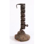 An 18th century wrought iron spiral candlestick, rudimentary ejector, softwood base a/f, 19cm high.