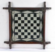 A Victorian Folk Art mirrored chess board, etched squares within geometric border, oak frame of