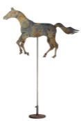 A 20th Century Folk Art painted metal horse sign, with articulated limbs, on stand, 138cm high.