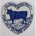 Rare late 19th century ceramic advertising plaque featuring a dairy cow, for the Oldham & District