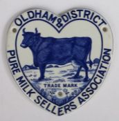 Rare late 19th century ceramic advertising plaque featuring a dairy cow, for the Oldham & District