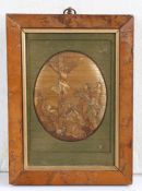 A 19th century oval straw-work picture of the crucifixion, possibly Napoleonic prisoner-of-war,