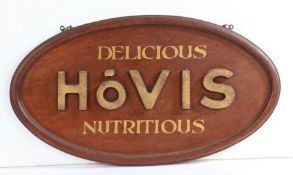 Mid 20th Century wooden Hovis bread shop advertising sign, the oval signed with gilt lettering and