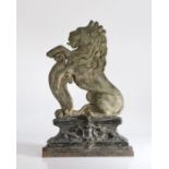 A Victorian cast iron door stop, in the form of a rampant lion on elaborate stepped plinth base,