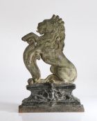 A Victorian cast iron door stop, in the form of a rampant lion on elaborate stepped plinth base,