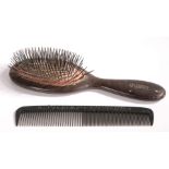 An oversized Folk Art wooden shop display hairbrush, stamped 'Hygex', 48cm long; together with an