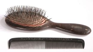 An oversized Folk Art wooden shop display hairbrush, stamped 'Hygex', 48cm long; together with an