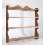 A set of Victorian painted wooden wall-hanging shelves, four graduated tiers, shaped scrollwork