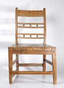 A primitive 19th Century Suffolk ball-back dining chair, pierced back with twin rows of three balls,