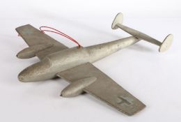 A WWII era wooden model of a Heinkel bomber, silver painted & bearing Luftwaffe markings, 37cm long,