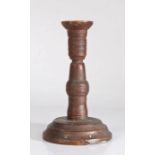 An 18th/19th century turned fruitwood candlestick, moulded plinth base, 19cm high.