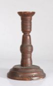 An 18th/19th century turned fruitwood candlestick, moulded plinth base, 19cm high.