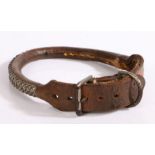 A late 19th/early 20th century brown leather dog collar with metal stud decoration, 65cm long.